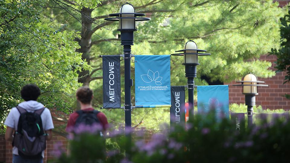 students walking under welcome banners