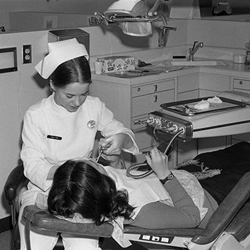 A dental hygiene student treats a patient.