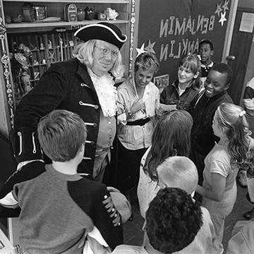 Historian Fred Krebs portrays Benjamin Franklin to a group of children.